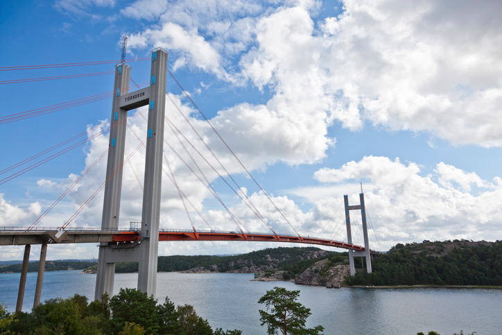 "The Tjorn Bridge in Sweden connects Stenungsund on mainland Sweden with the island Tjorn on the western coast of the country. The length is 664 m, the span width is 366 m, and the height above the water is 45 m.Inaugurated in 1981, the bridge was built in record time after its predecessor, the Almo Bridge, which had been inaugurated in June 1960, collapsed after the Tanker Star Clipper collided with it on 18 January 1980 in fog and darkness. Eight people died in 7 vehicles that plunged into the sea before the bridge could be closed. The base of the old bridge can just be seen on the far side.Adobe RGB 1998 profile."